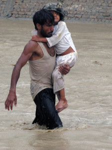 An Afghan man carries a young child to safety during encroaching flood waters in Nari Shahi village, Beshood District of eastern Afghanistans Nangarhar province July 28. The flooding was caused when more than 6 inches of rain enveloped the area in a few hours. The platoon was returning from a patrol in the district and stopped to help the villagers when they realized the dangers of the situation. (U.S. Army courtesy photo)