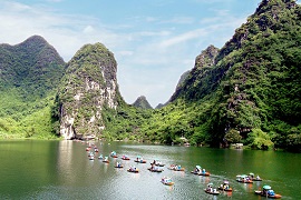 Przeprawianie turystów przez Czerwoną Rzekę łodzią w okolicy wietnamskiego zespołu krajobrazowego jest pomysłem miejscowych na lokalną przedsiębiorczość. Źródło WTD.UNWTO.ORG